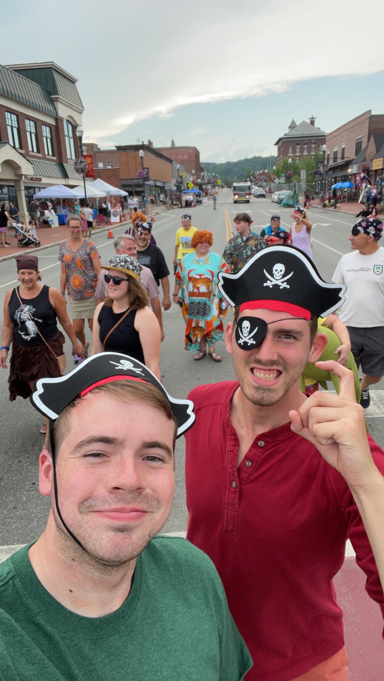 Two strapping young men dressed up as pirates in the middle of a street